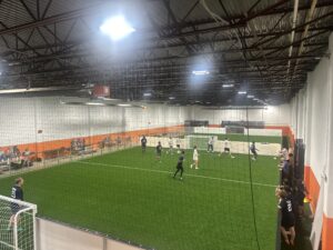 Adult indoor soccer league play at Total Soccer Center facility.